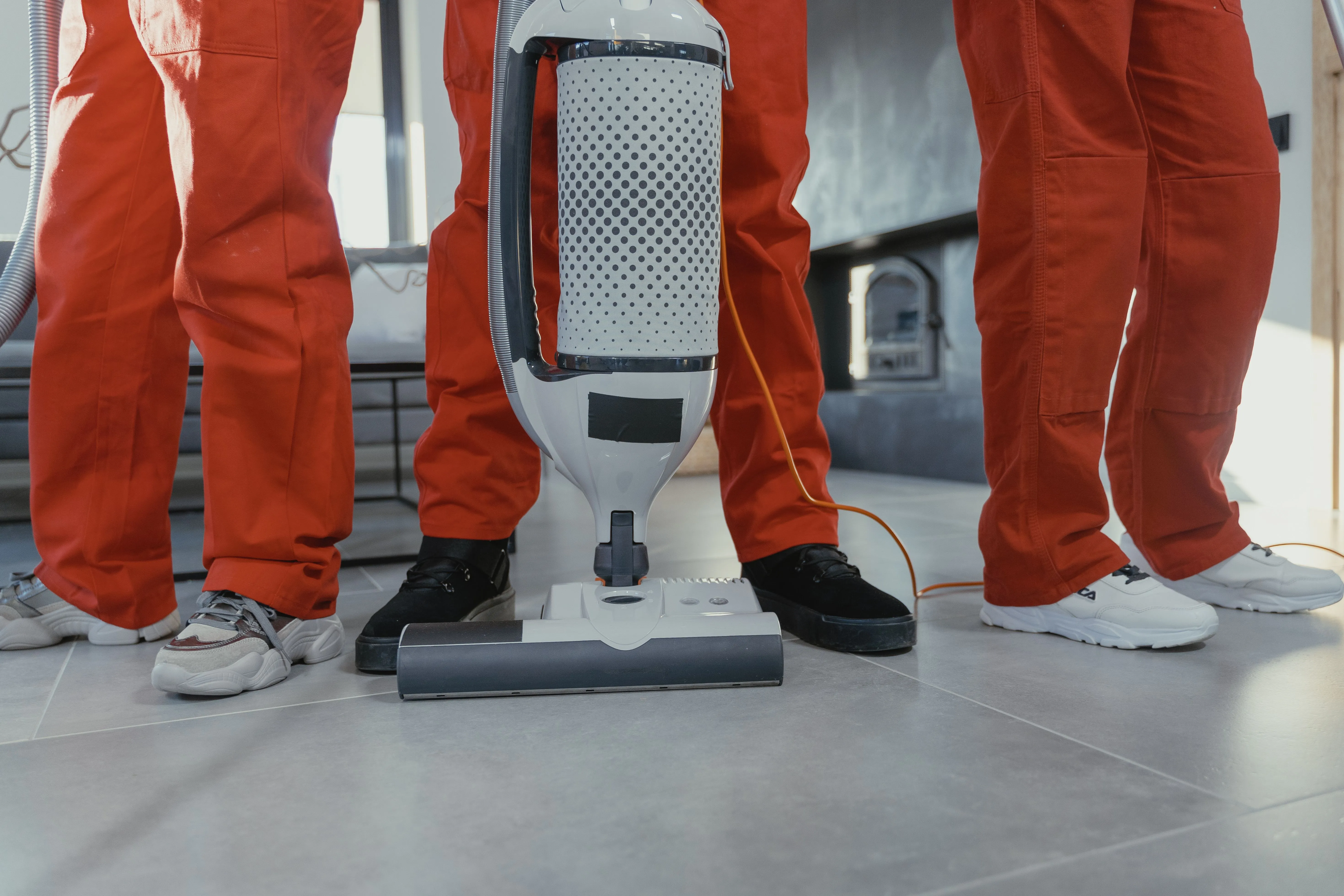 The Lift Shift Shine crew, in matching uniforms, on the job with cleaning equipment